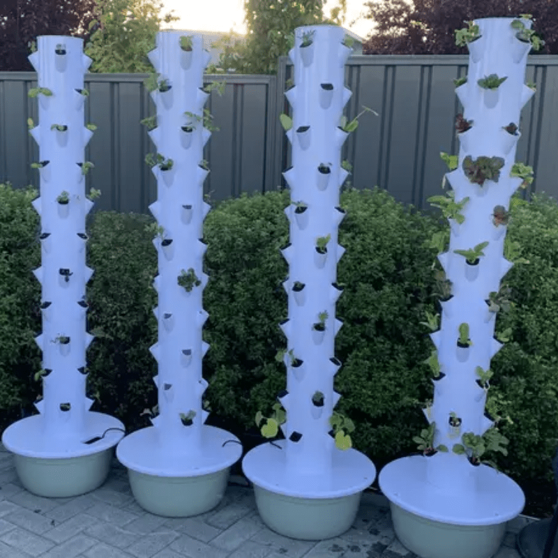 GreenFutureHydro Vertical Hydroponic Tower in an outdoor garden, perfect for growing vegetables and herbs.