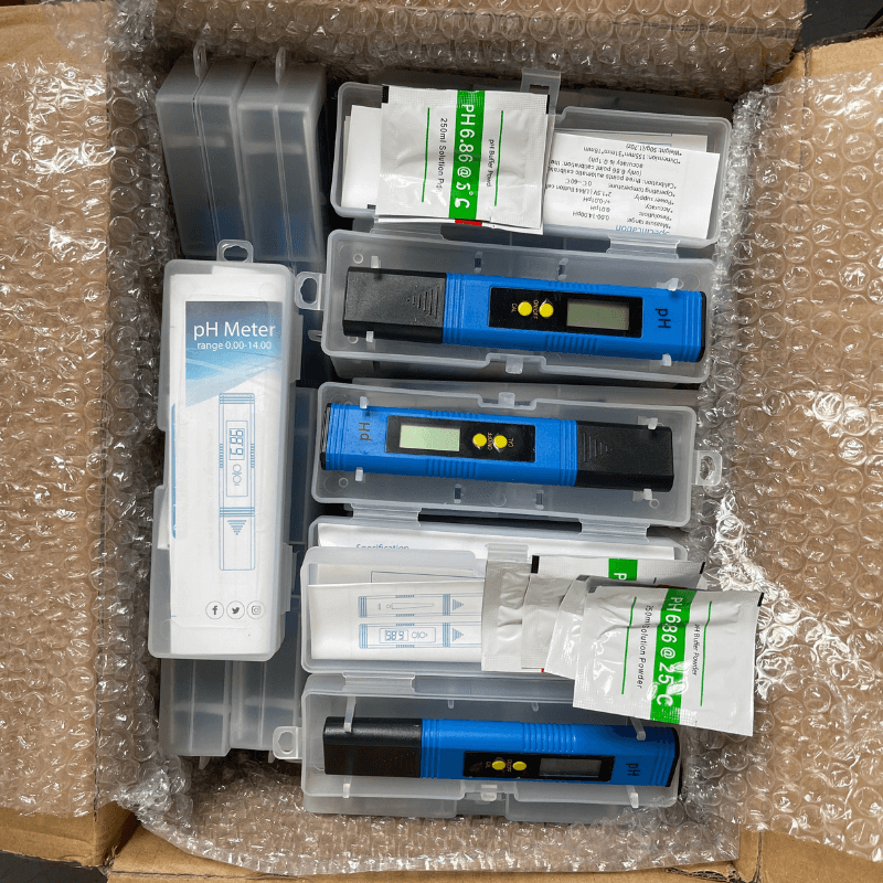 Unpacked view of export-ready pH meters with all components included.