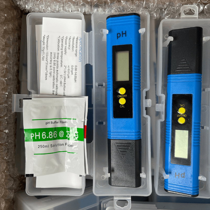 Complete pH meter set including calibration buffer powders and protective cases, ready for use.