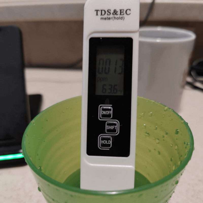 TDS EC meter on green pad