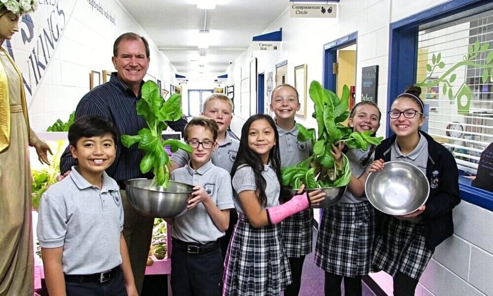 students learning hydroponics with vertical hydroponic tower in school STEM classroom