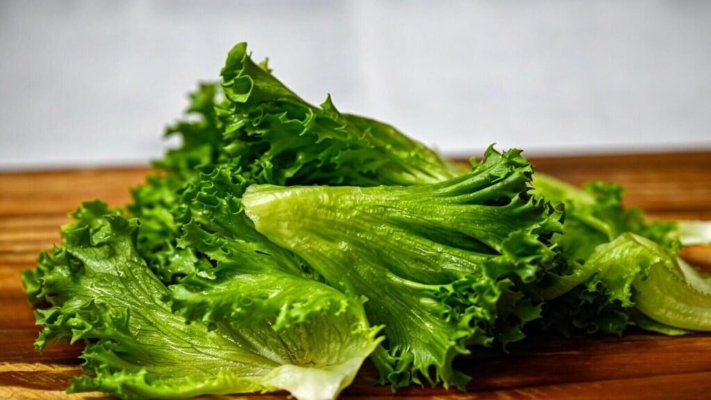 Washing leafy vegetables for salad preparation in kitchen.